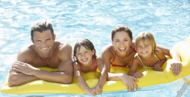 Mother and father having fun with kids in the pool