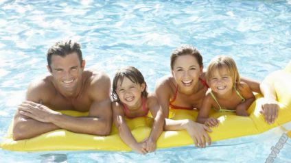 Mother and father having fun with kids in the pool